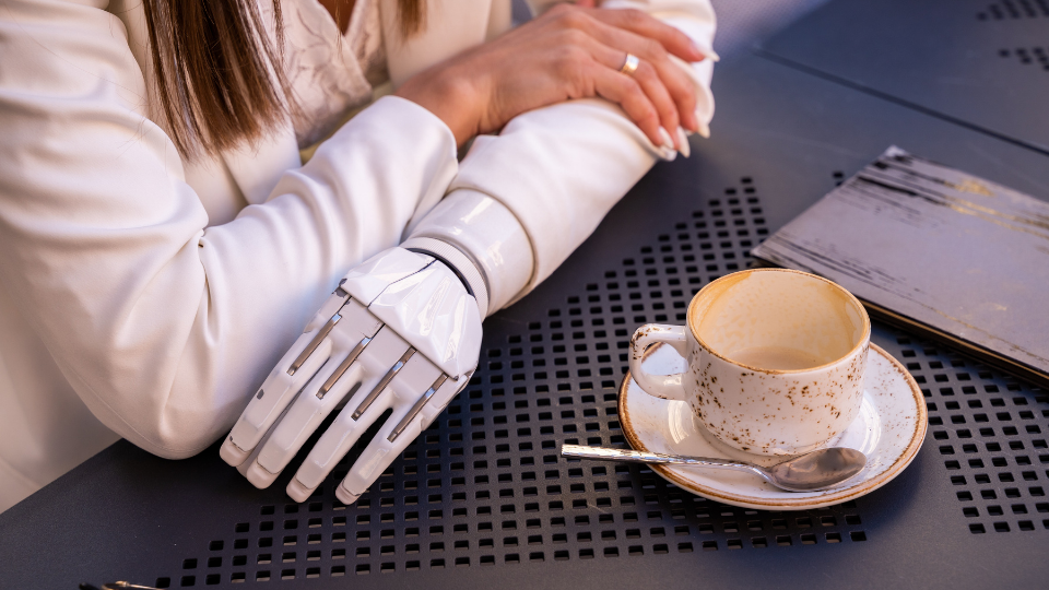 woman with a robot arm having coffee