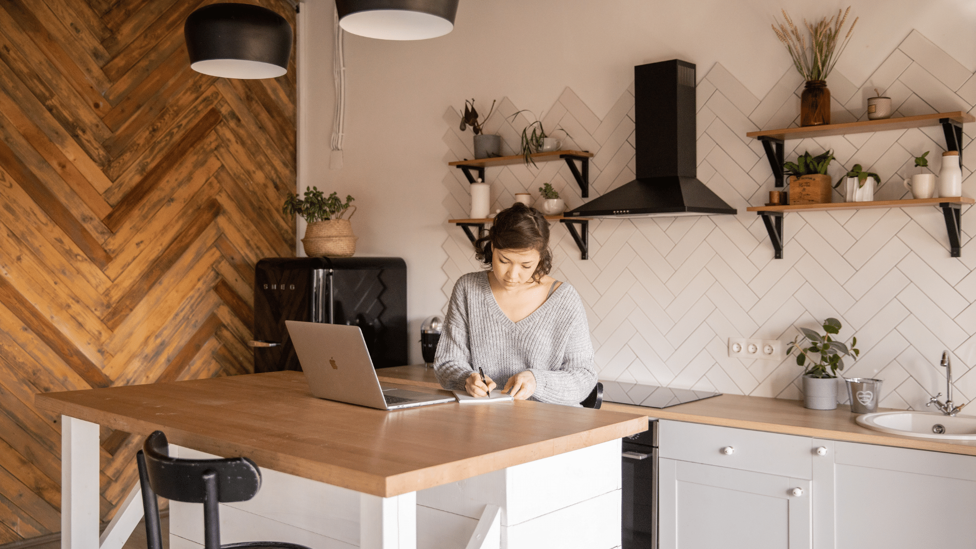 Woman on computer in kitchen